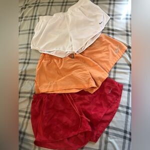 Nike Dri-Fit shorts, all size Medium. Set includes white, pink and orange shorts